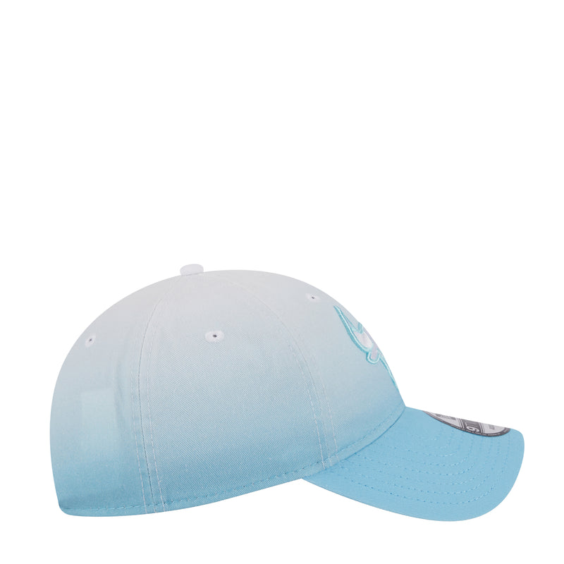 Light blue ombre baseball cap with small embroidered bull logo at side, adjustable strap