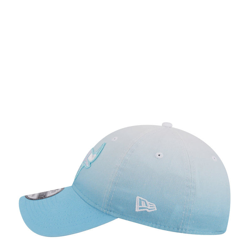 Light blue ombre baseball cap, front-left angle with embroidered bull logo and curved brim