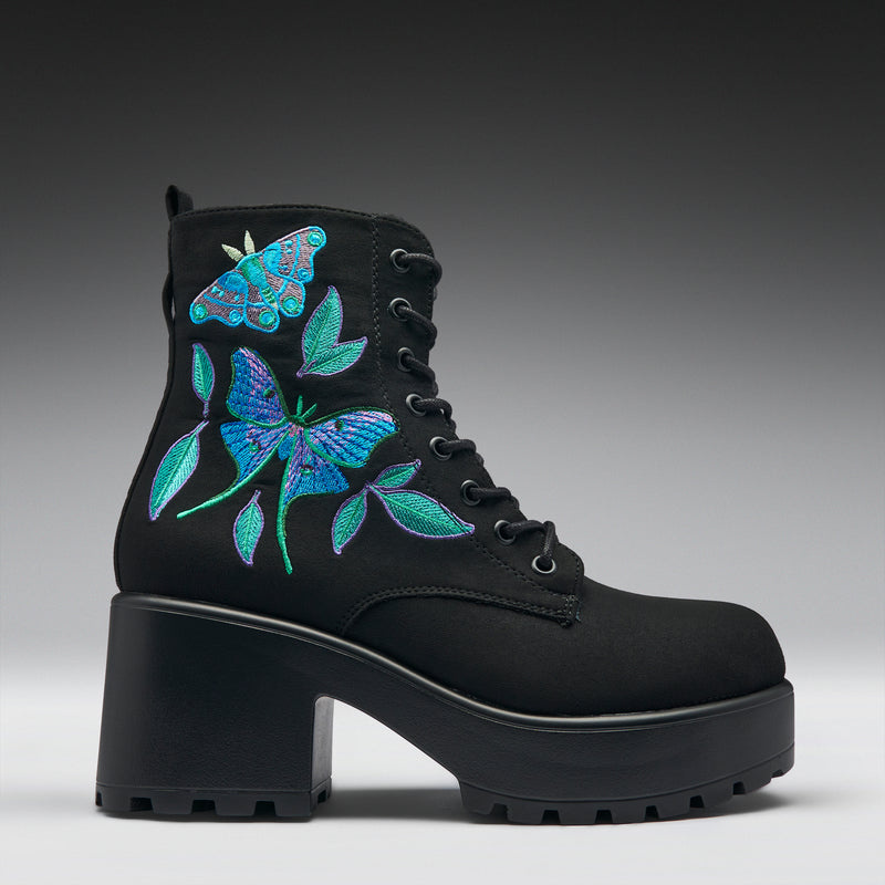 Black boot with blue butterfly embroidery on a gray background