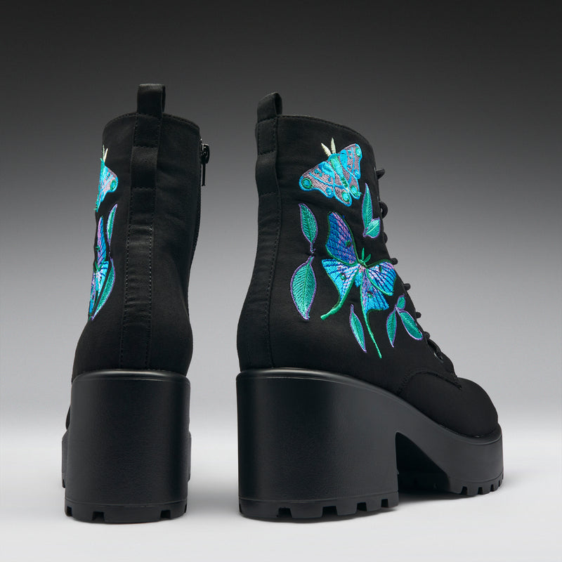 Black boots with butterfly embroidery on a gradient background