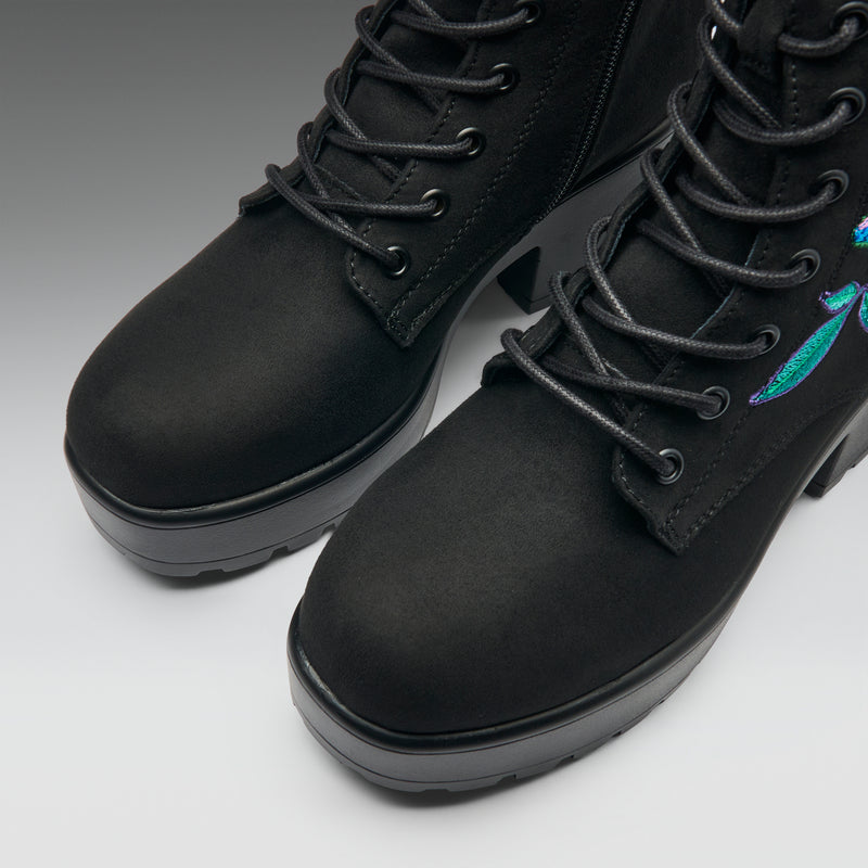 Black leather boots with colorful design on a white background