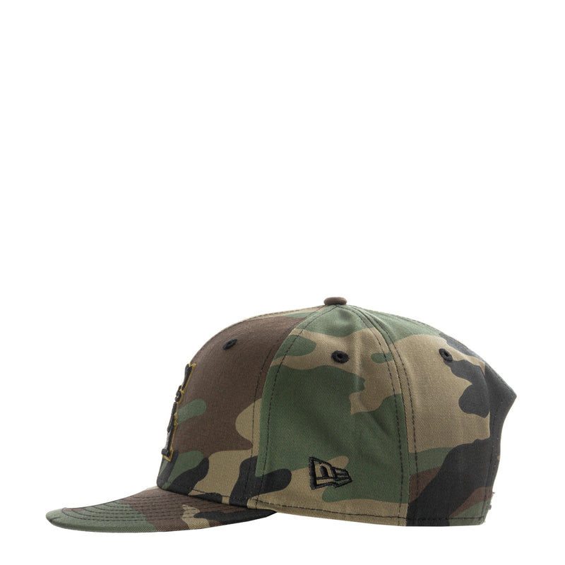 Camo baseball cap with small front logo patch and curved brim, snapback closure