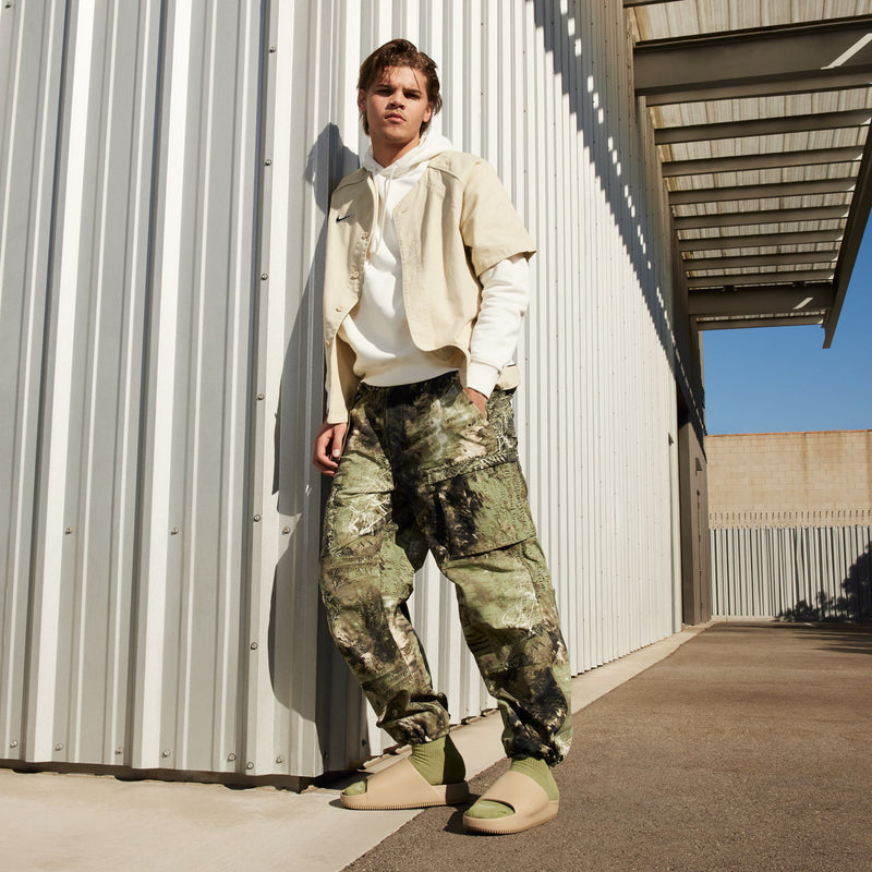 Khaki slide sandals on model with camo pants