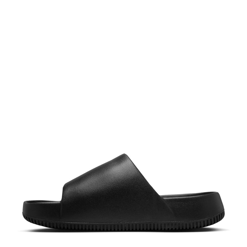 Black slide sandal with wide strap and Nike swoosh logo, side profile