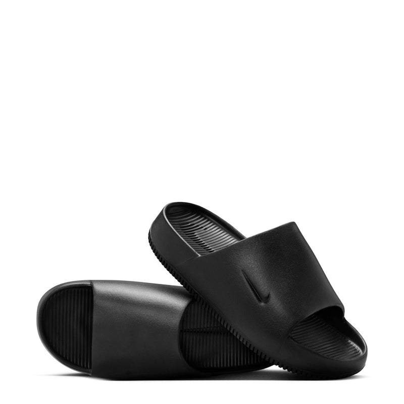 Pair of black slide sandals with Nike swoosh on straps, studio angle view