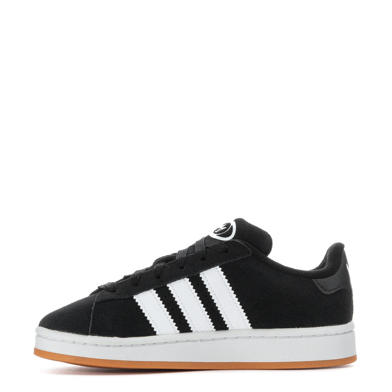 Kids black low-top sneakers, side view with white stripes and gum outsole