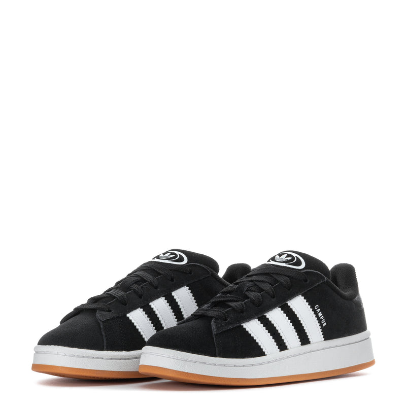 Kids black low-top sneakers, pair view with white stripes and gum sole