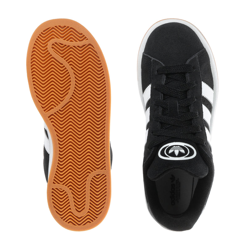 Kids black sneakers showing outsole with gum tread and front lace upper