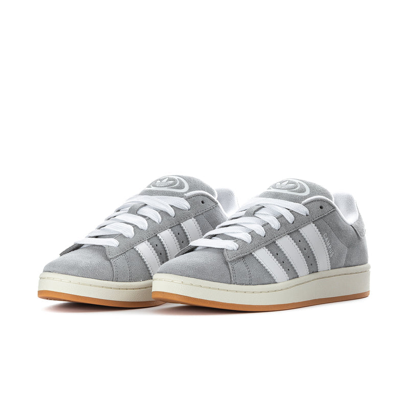 Pair of men's grey low-top sneakers with white three-stripe side panels and gum sole