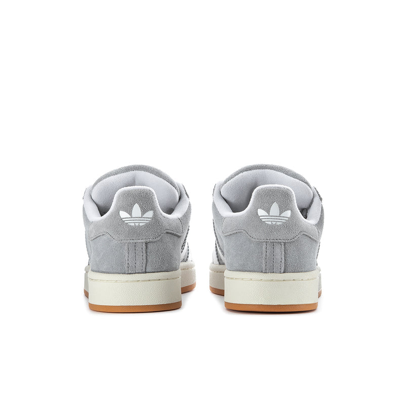Men's grey low-top sneakers with heel tab and white logo stripes; gum outsole
