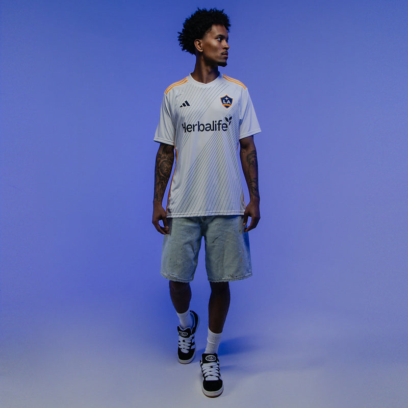 Men's adidas Campus 00s sneakers worn with light shorts and striped jersey
