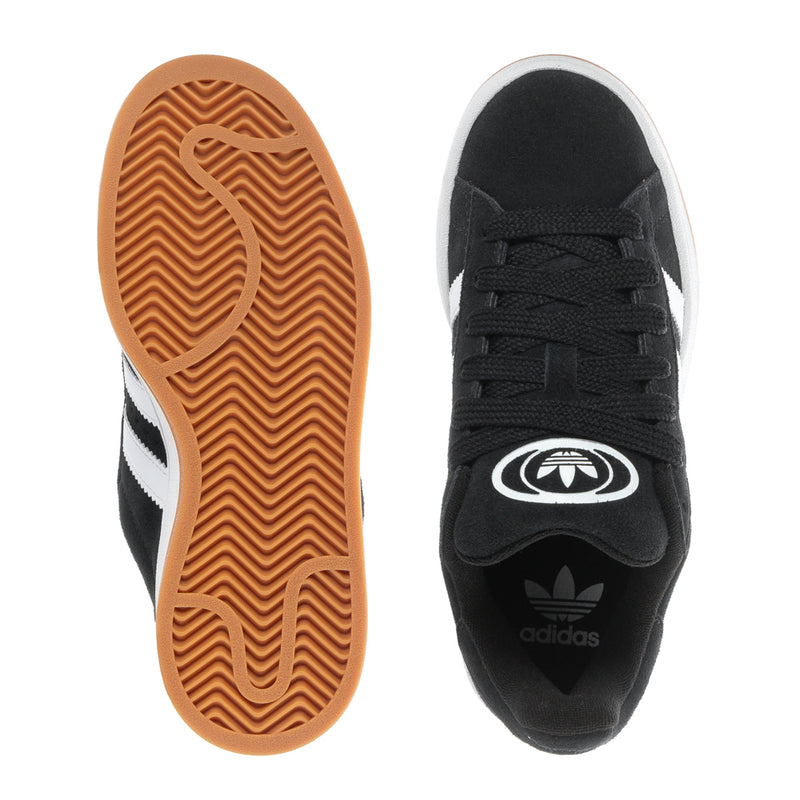 Youth black sneaker bottom view with gum-brown tread and trefoil logo
