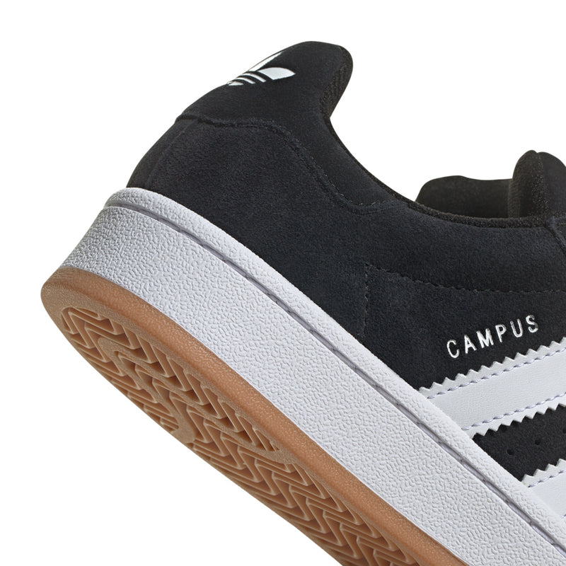 Youth black suede sneaker with white midsole and gum-brown outsole tread