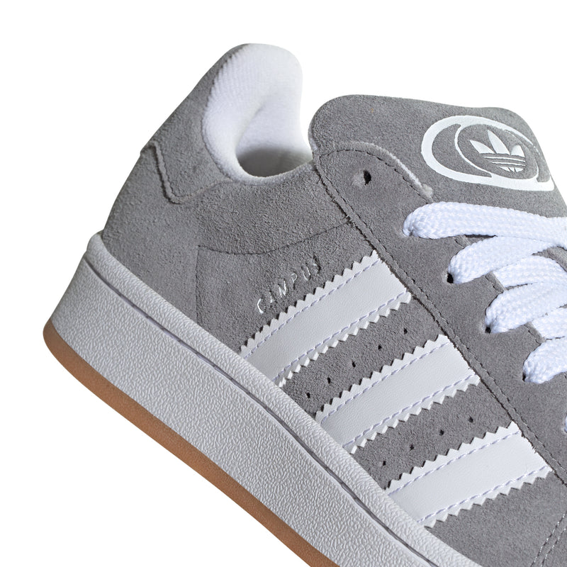 Youth Adidas Campus sneaker close-up: grey suede, white stripes, lace detail
