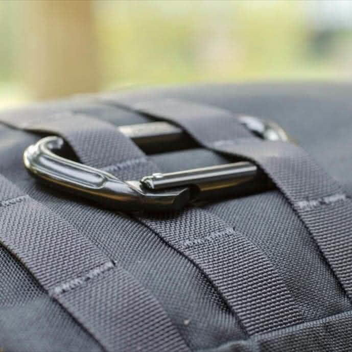 Close-up of black GORUCK rucksack with MOLLE webbing and a clipped carabiner