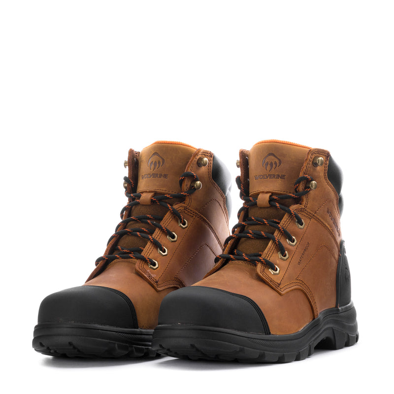 Pair of men's tan steel toe boots with black accents and orange lace details.