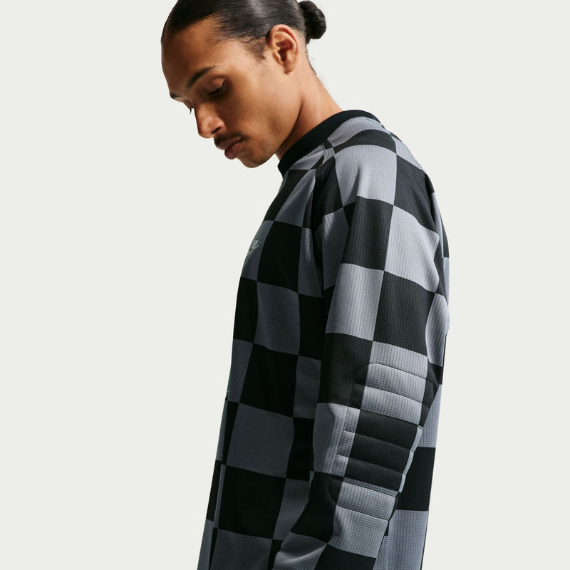 Mens checkered goalie top, side view of black and gray checker pattern long sleeves