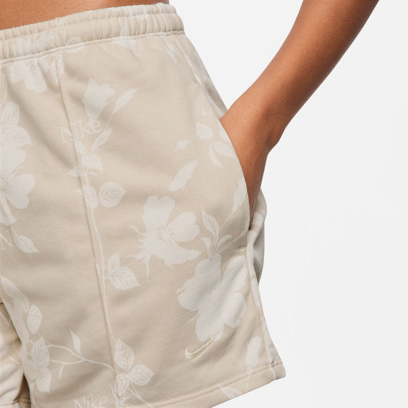Light beige-tan floral shorts close-up: elastic waistband and all-over flower print