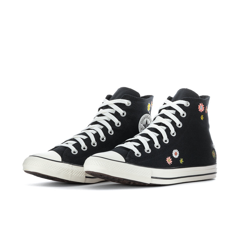 Black high-top Converse sneaker with floral embroidery and white lace-up, side view