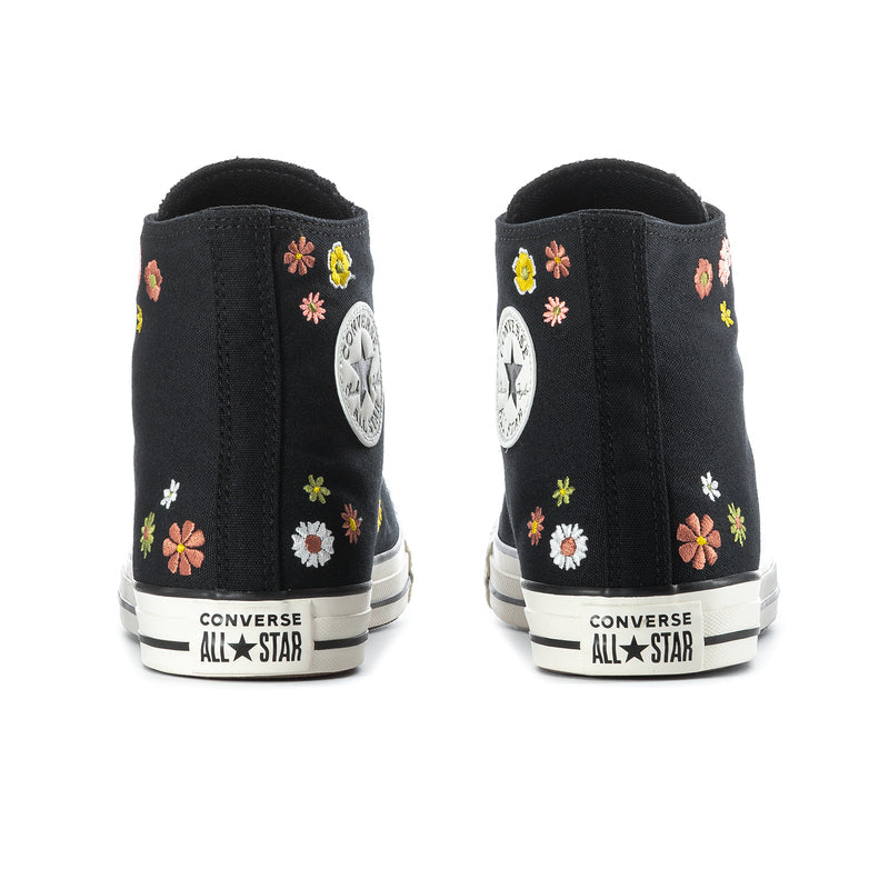 Black high-top sneaker backs with floral embroidery and Converse All Star heel patch