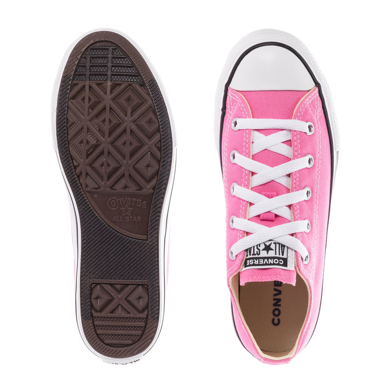 Pink low-top canvas sneakers showing outsole tread and lace-up upper.