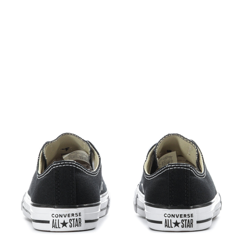 Kids black low-top sneakers back view, All Star heel patch on white rubber sole