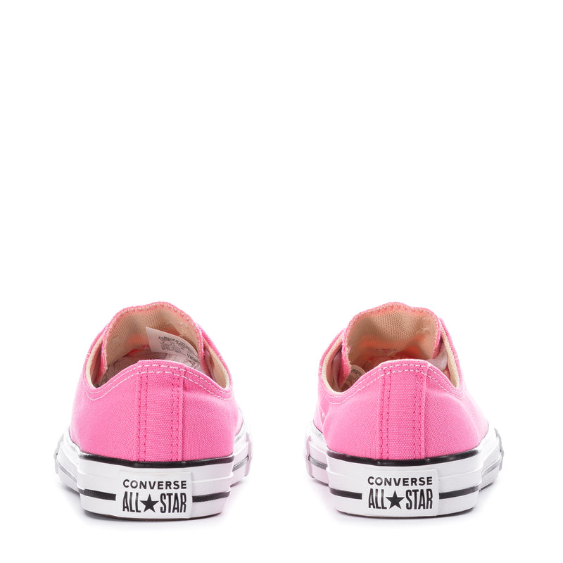 Pink kids low-top canvas sneakers with Converse All Star branding on the heel.
