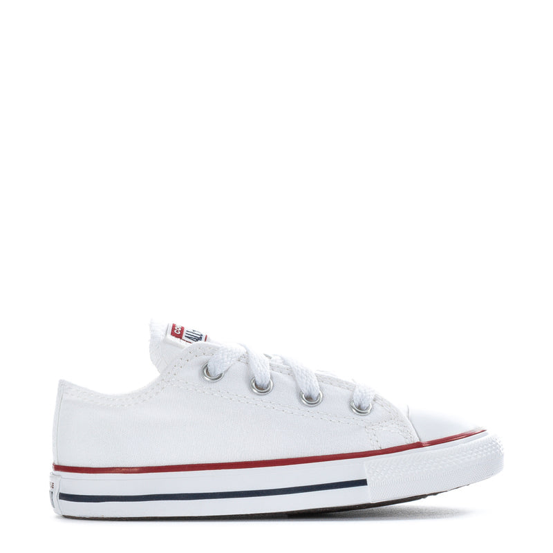 White toddler low-top canvas sneakers with lace-up eyelets and red/blue stripe sole