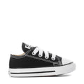Toddler black Chuck Taylor All Star ox sneakers, side view with white laces and toe cap