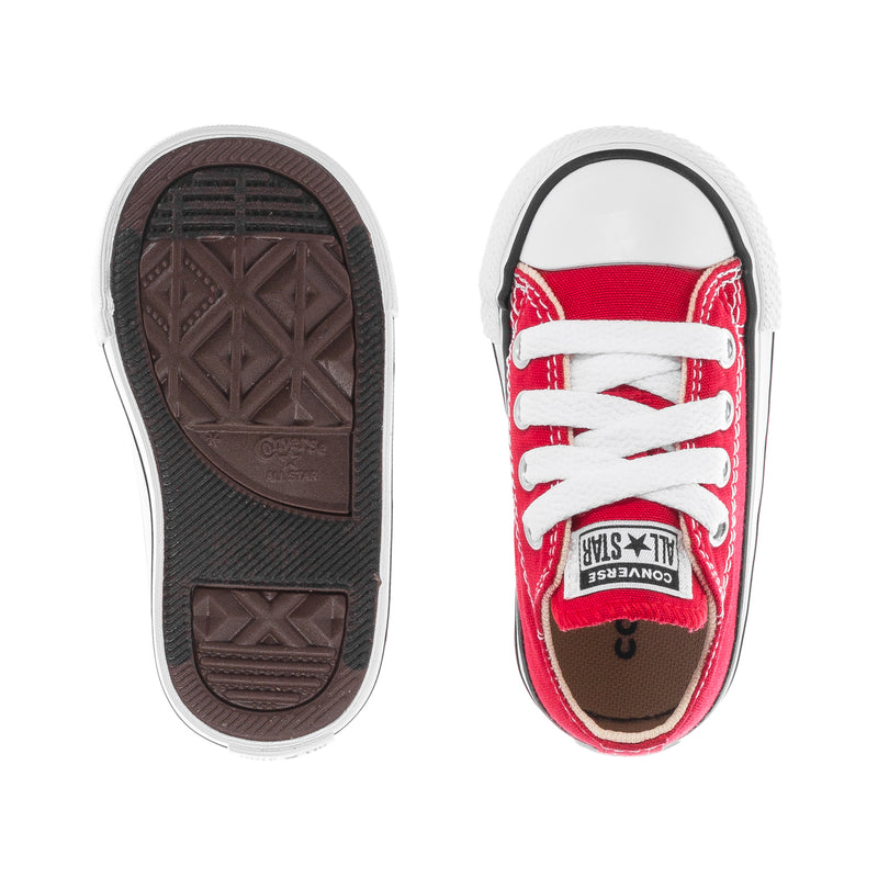 Toddler red low-top sneakers showing textured rubber outsole and heel interior