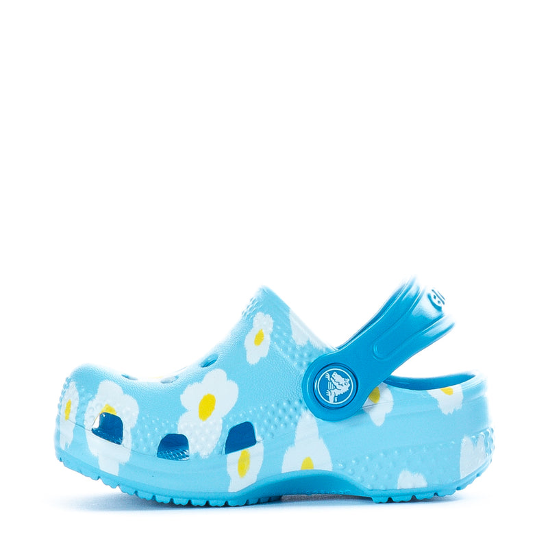 Infant light blue clog with daisy-and-house print, blue heel strap and logo