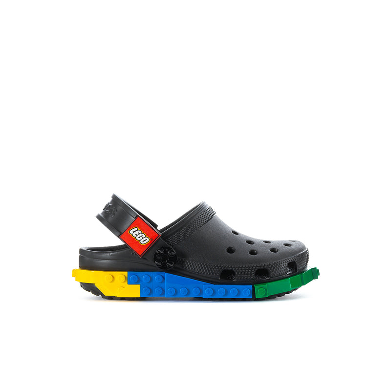 Kids black clog with perforations, LEGO strap and colorful outsole blocks.