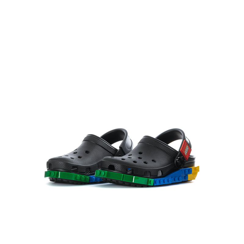 Kids black clogs with perforations, dual straps, colorful tread outsole.