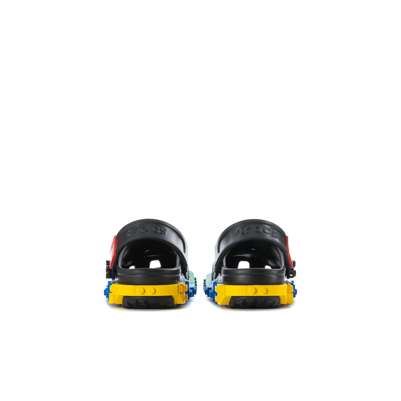 Kids black clogs from heel view with colorful rocker-style outsole blocks.