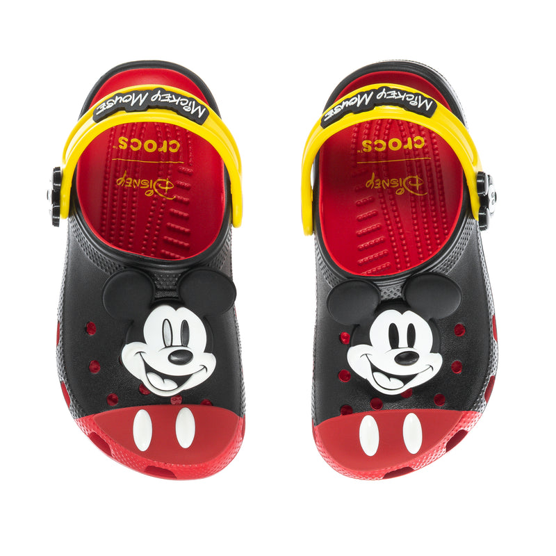 Pair of kids clogs showing Mickey Mouse face, black upper with red footbed and yellow trim