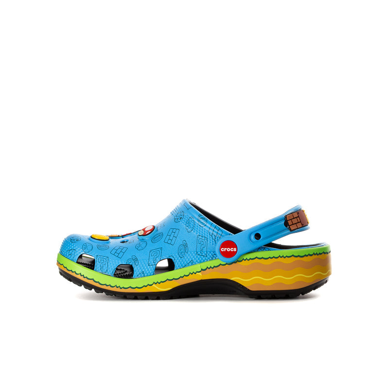 Kids blue clog with side graphic details, green trim, and black-and-yellow outsole