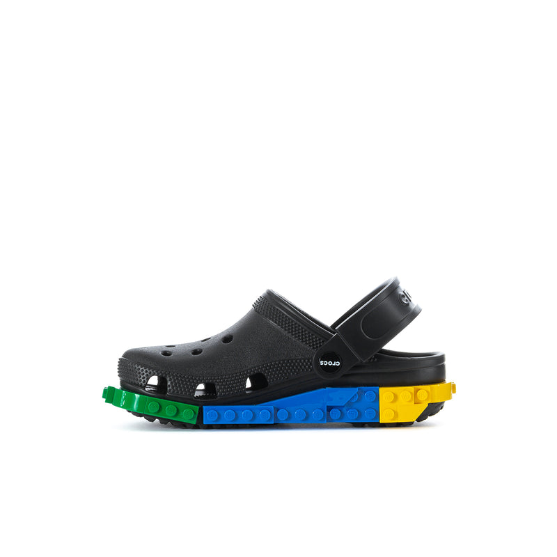 Kids black clog with perforations, black strap, colorful LEGO-block outsole.