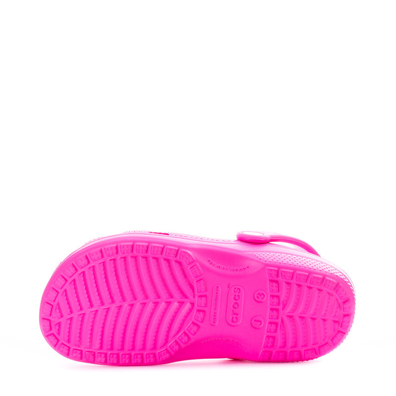 Kids' pink clog outsole view with treaded sole and 'crocs' logo
