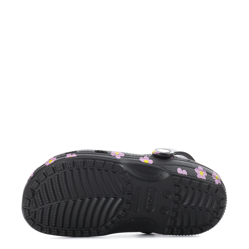 Kids' black clog with pink flower print, textured tread outsole side view