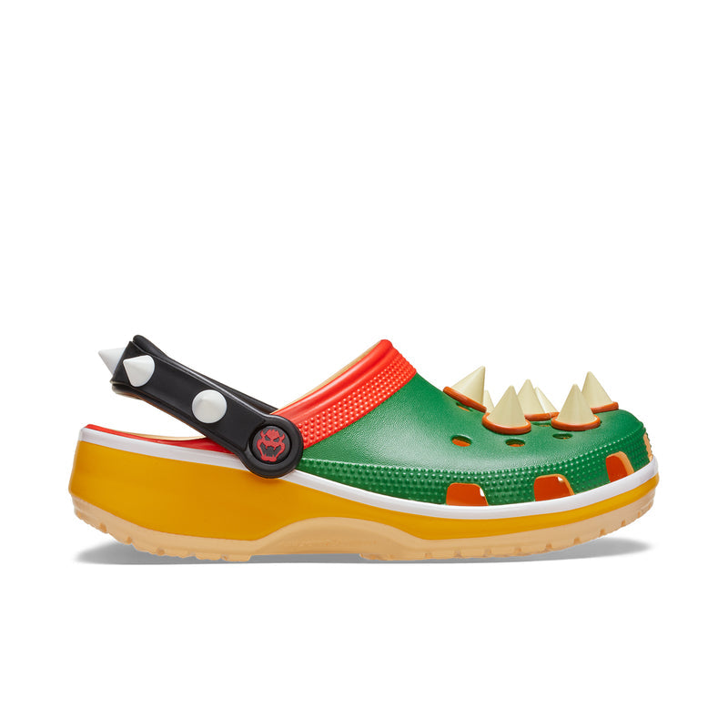 Men's classic clog in green with red strap, white-dot accents, and yellow sole.