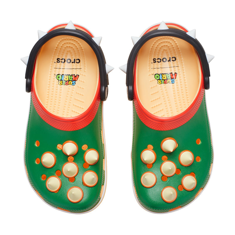 Men's classic clog, green top with raised ventilation holes and spikes, red rim.