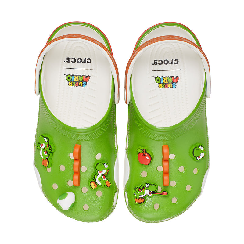 Green clogs showing white interior footbeds with printed character graphics