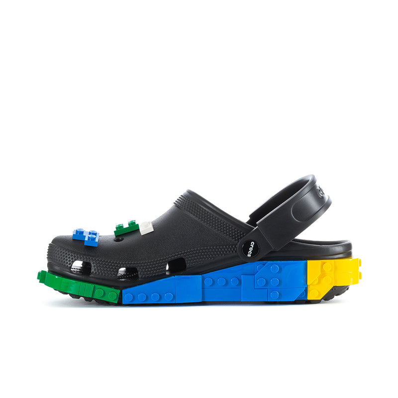 Men's black clog with strap detail and LEGO-brick platform sole in blue and yellow