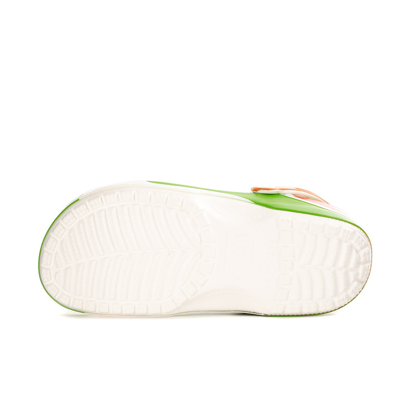 Underside of green clogs with white outsole tread and logo trim