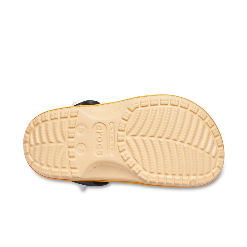Men's clog outsole, beige traction tread; green upper with black strap.