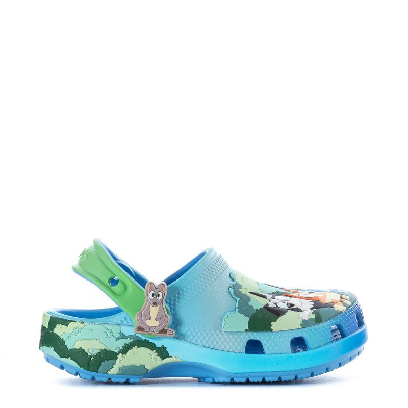 Toddler light-blue clog with animal scene print and green heel strap, side view.