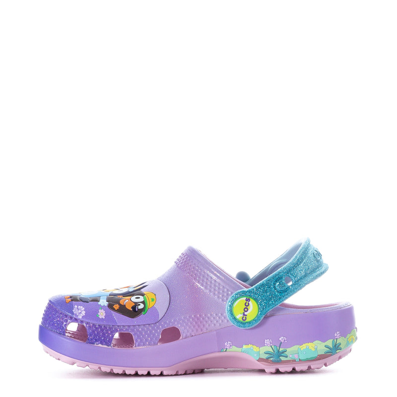 Purple toddler clog with teal heel strap and colorful side graphic, angled view