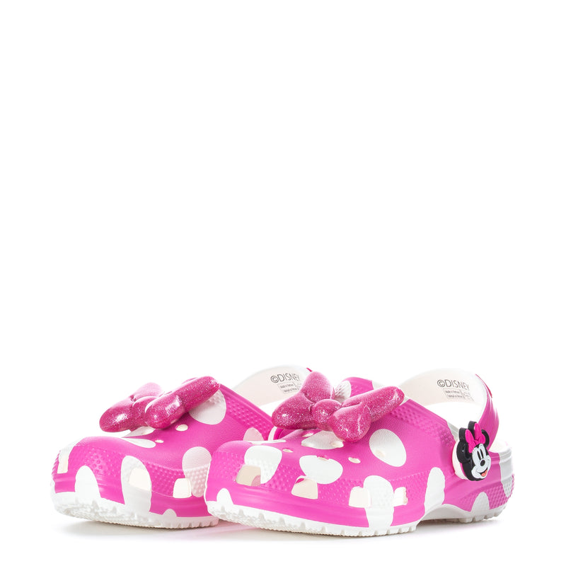 Toddler pink Minnie clogs with white dots and bow detail, side view
