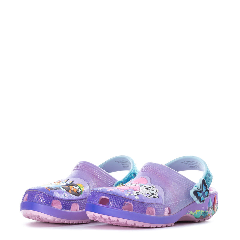 Pair of purple toddler clogs with teal accents and cartoon scene, front view