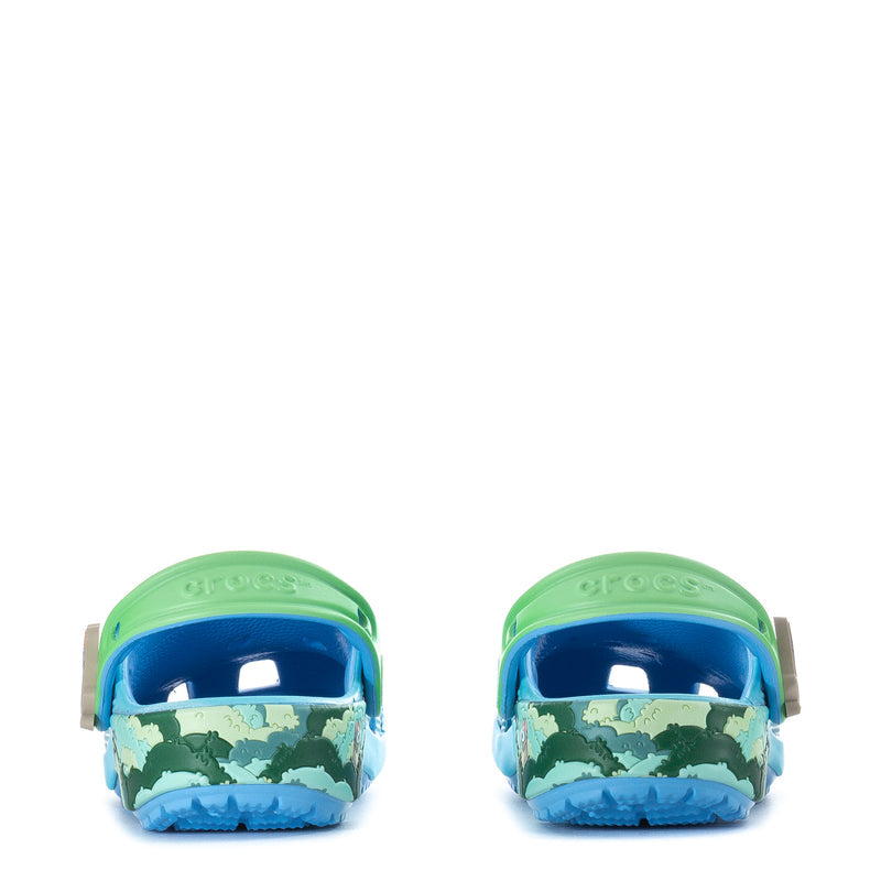 Toddler blue clog with animal print and green accents, front view.